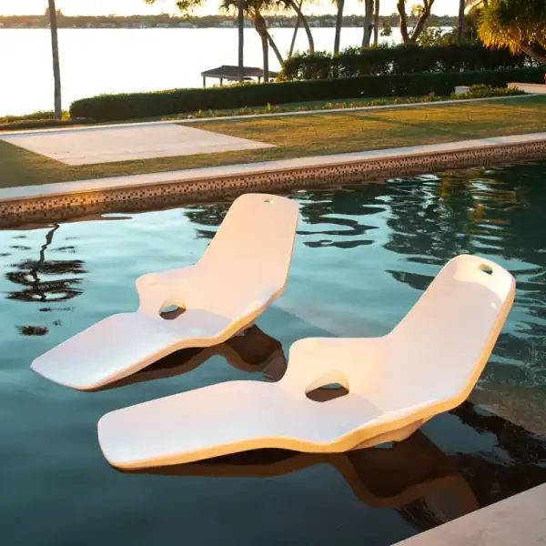 Tenjam Shayz in-pool lounger pair in sunset pool setting|Tenjam Shayz lounger white granite poolside|Tenjam Shayz lounger vertical view white granite|Tenjam Shayz lounger lifestyle in pool|Tenjam Shayz lounger angled view|Tenjam Shayz lounger overhead view|Tenjam Shayz lounger product detail