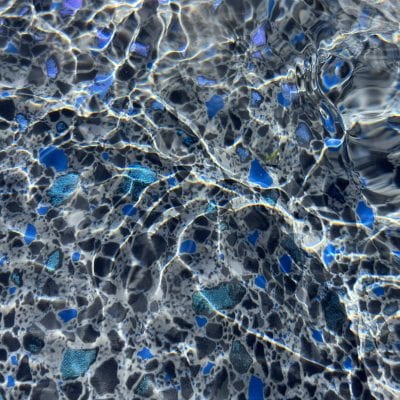 Sunlight dances on rippling water, reflecting Midnight Opal pool supplies in Long Island, NY.