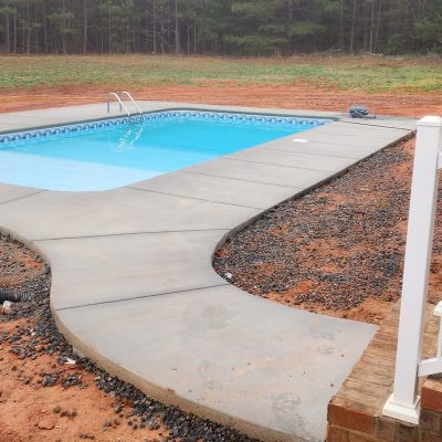 A small backyard pool features Caswell Beach Tile and Sandy Point Floor, popular in Long Island homes.