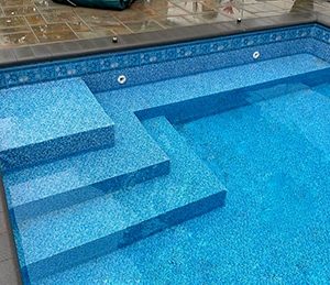 Cape Elizabeth tile in an oceanside floor design is featured at a pool supplies store in Long Island.