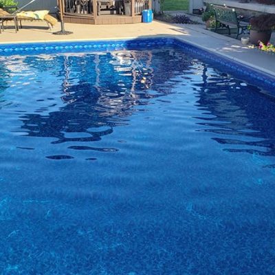 A close-up of Sea Storm Floor tiles by Royal Island Tile displayed in a Long Island pool supply store.