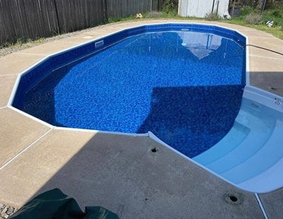 A sparkling pool with Royal Island Tile Sea Storm Floor is ideal for pool supplies in Long Island.