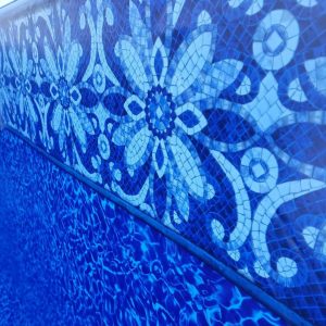 Sea Blossom Tile in a blue floral mosaic design decorates a pool wall, ideal for Long Island and Queens, NY.