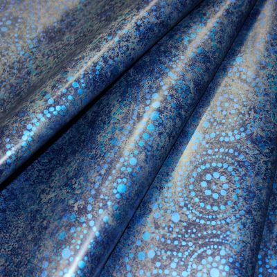 Folded Starlight Swirl blue fabric with metallic dots inspired by pool supplies in NY, shown close-up.