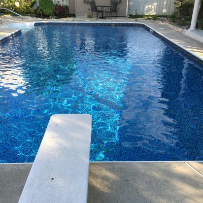 A backyard pool featuring Sandy Cay Tile/Runaway Bay Floor, perfect for patios and sheds in Long Island.