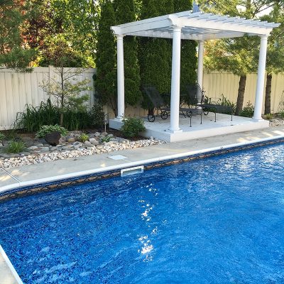 A modern backyard pool area features Sandy Cay Tile and Runaway Bay Floor, ideal for Long Island homes.