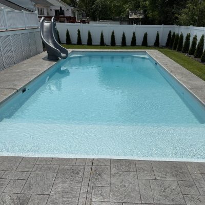 A modern pool area with Caswell Beach Tile flooring, available in Long Island and Queens, NY.