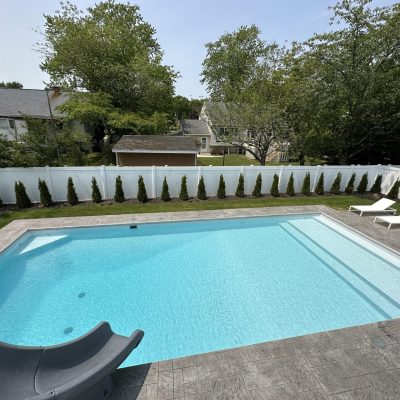 A Caswell Beach Tile Sandy Point Floor is installed around a backyard pool in Long Island, NY.