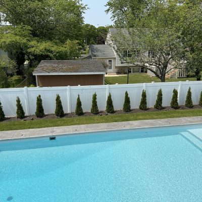 A sparkling pool features Caswell Beach Tile and Sandy Point Floor, ideal for Long Island backyards.