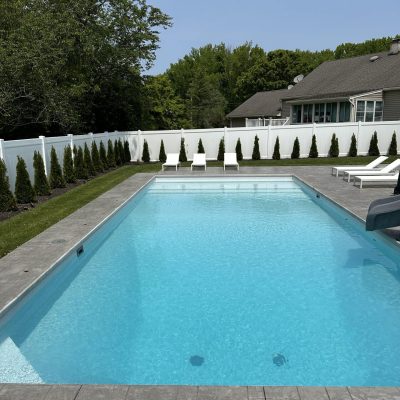 Rectangular backyard pool in NY with Caswell Beach Tile and Sandy Point Floor, ideal for Long Island homes.