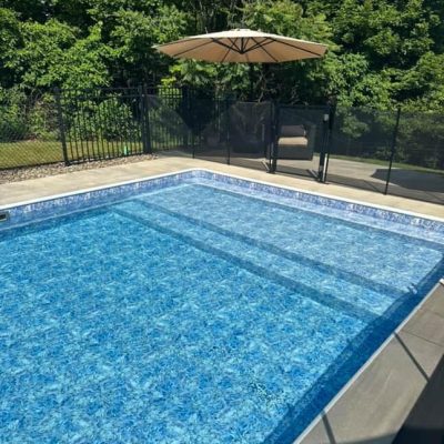 A pristine blue pool glistens in the sun, reflecting Moonstone Bay’s pool supplies expertise.