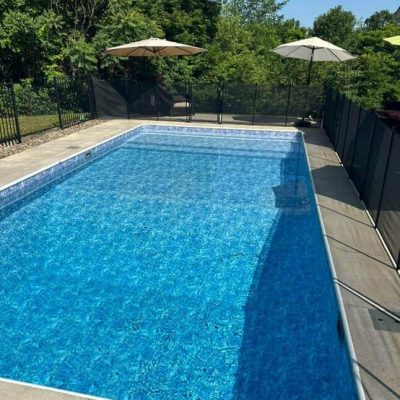 A backyard pool features Moonstone Bay supplies, creating a relaxing oasis in Long Island, New York.