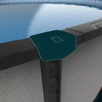 A corner protector sits on the edge of an Ember Drift 27' Round Resin Above Ground Pool by the water.